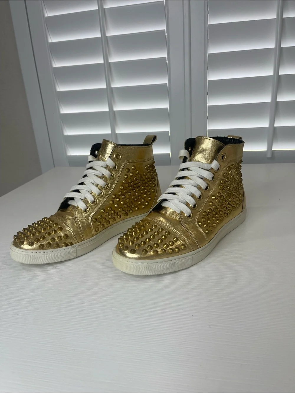 Metallic Gold High-Top Sneakers with Stud Details by Rodney P. Hunt